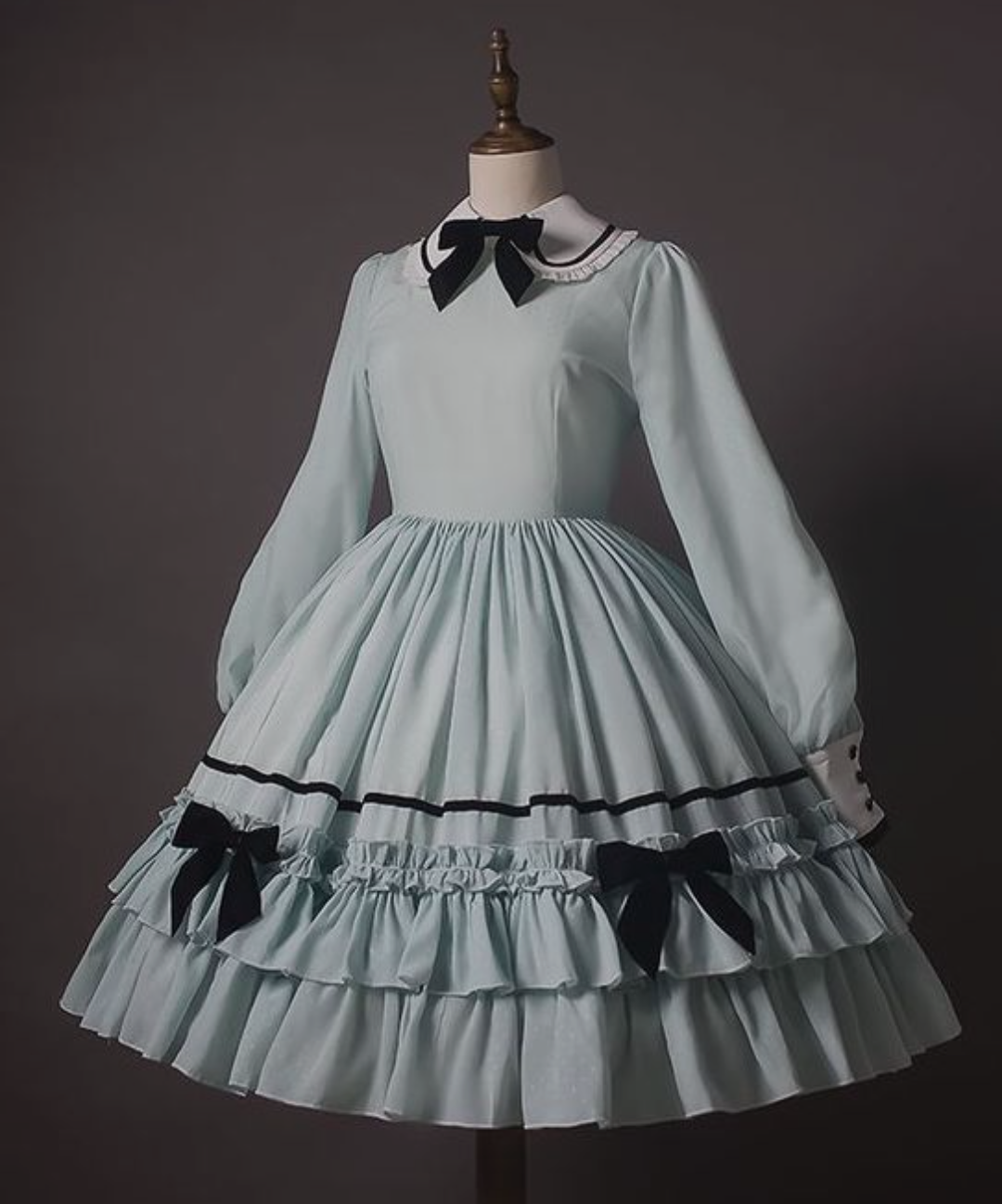 Pale blue dress with three black bows